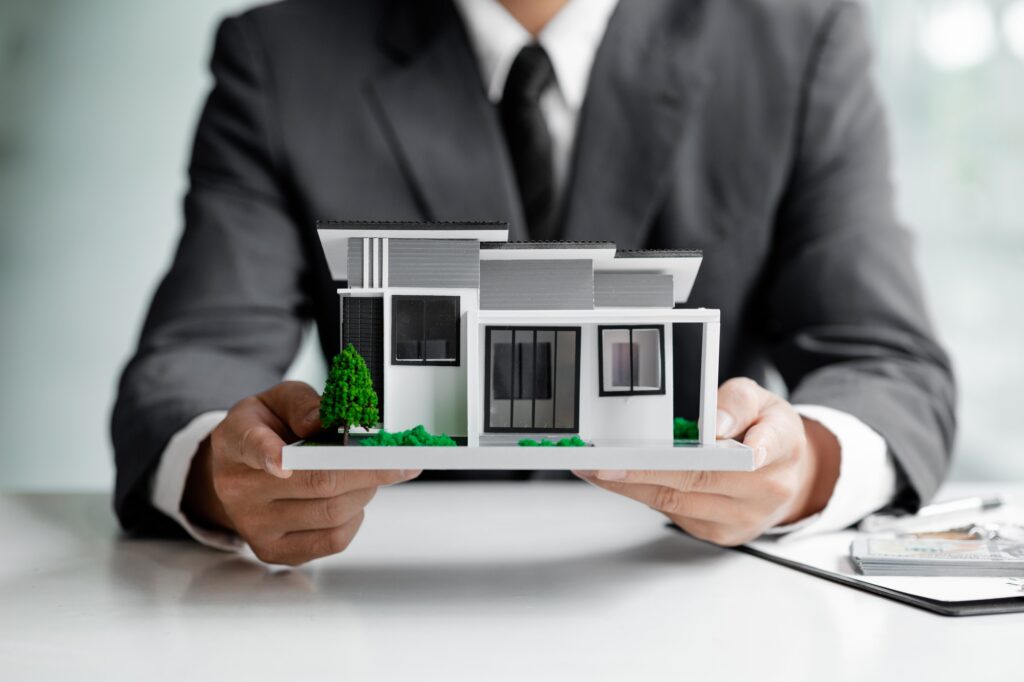 Real estate agents are holding a housing model of the project.