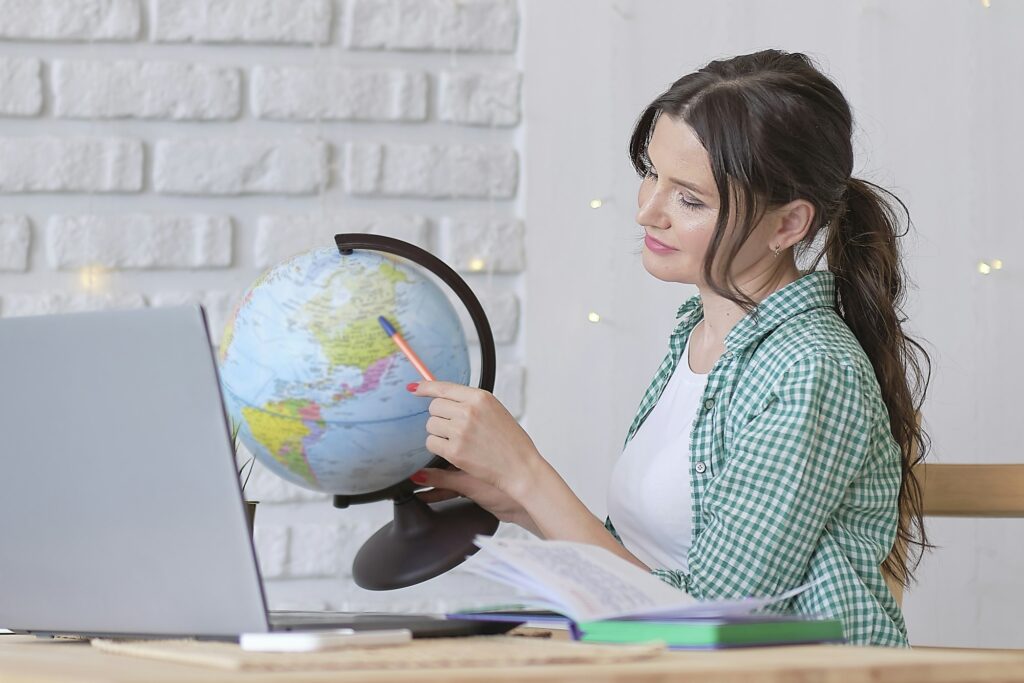 mixed-race business woman globe to convey she works for an international company.