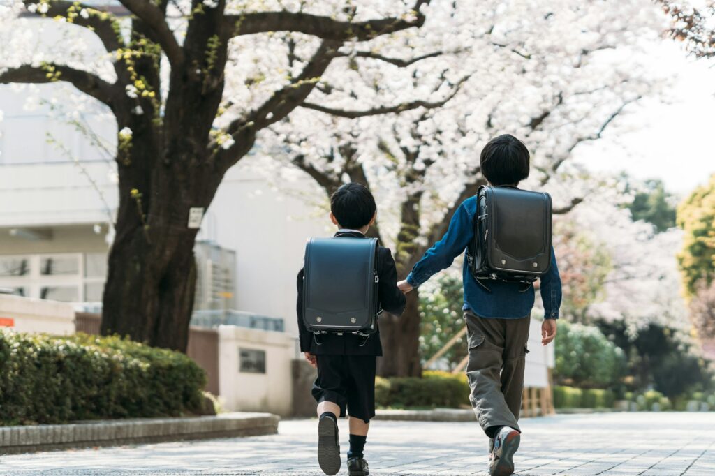 Japanese upper elementary school students and first graders holding hands