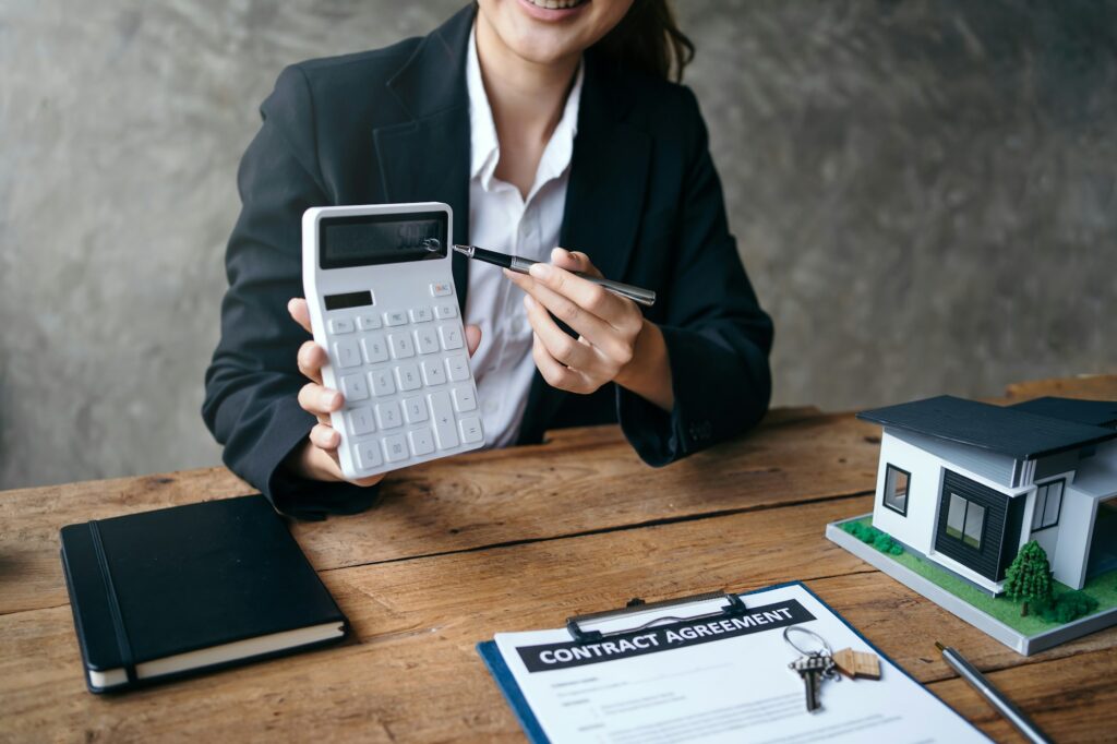 Real estate agent and client are negotiating prices before signing and discussing home purchases, in